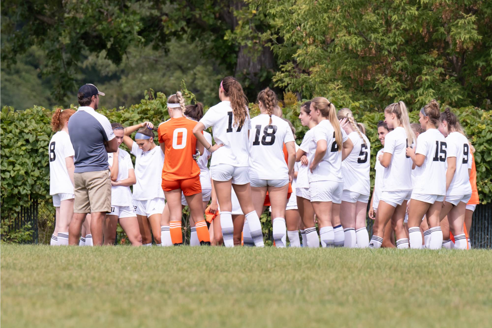 The team listening to coach before a game